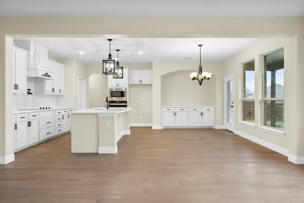 a view of a big room with a ceiling fan and window