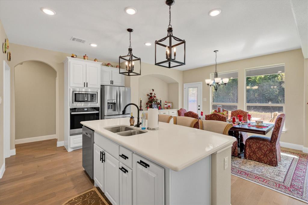 4434 Verbena Street Midlothian, TX 76065 - Photo 21 of 32 a large kitchen with a table and chairs