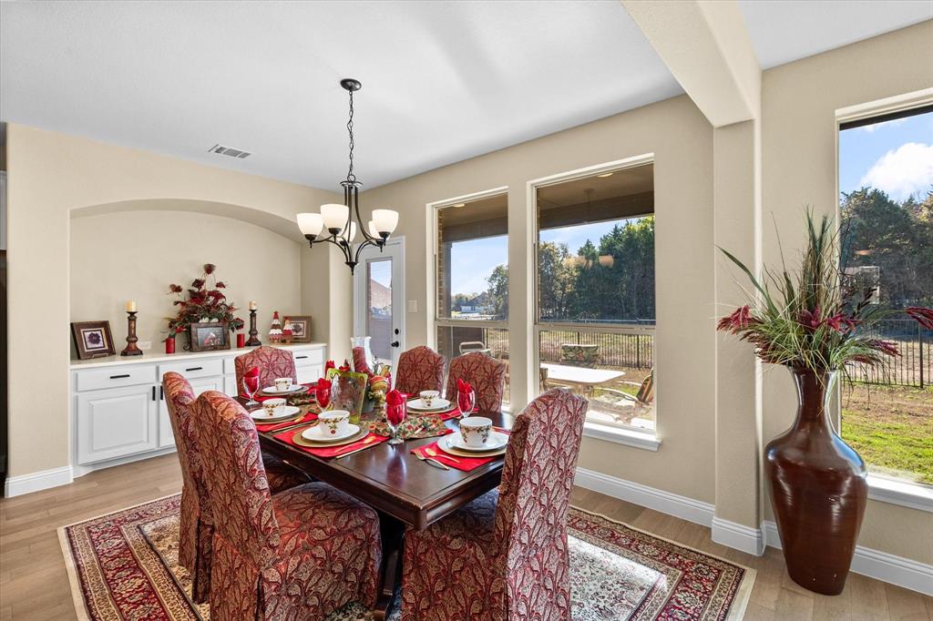 4434 Verbena Street Midlothian, TX 76065 - Photo 22 of 32 a dining room with furniture a chandelier and window