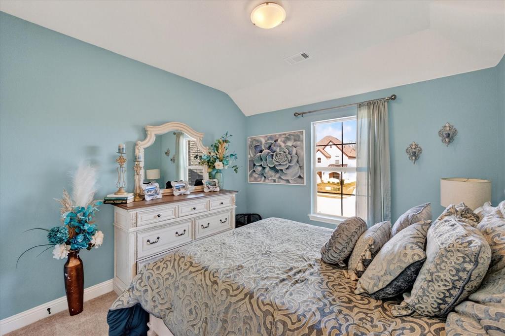 4434 Verbena Street Midlothian, TX 76065 - Photo 25 of 32 a bedroom with a bed and a dresser