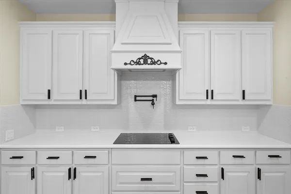 a kitchen with white cabinets and white appliances