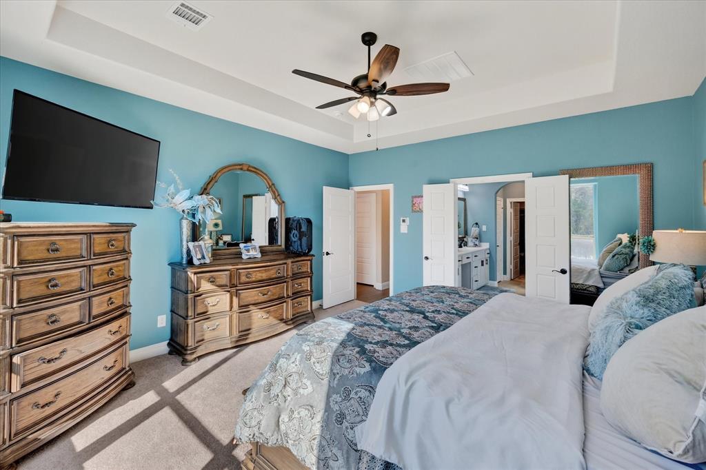 4434 Verbena Street Midlothian, TX 76065 - Photo 9 of 32 a bedroom with a bed and a flat screen tv