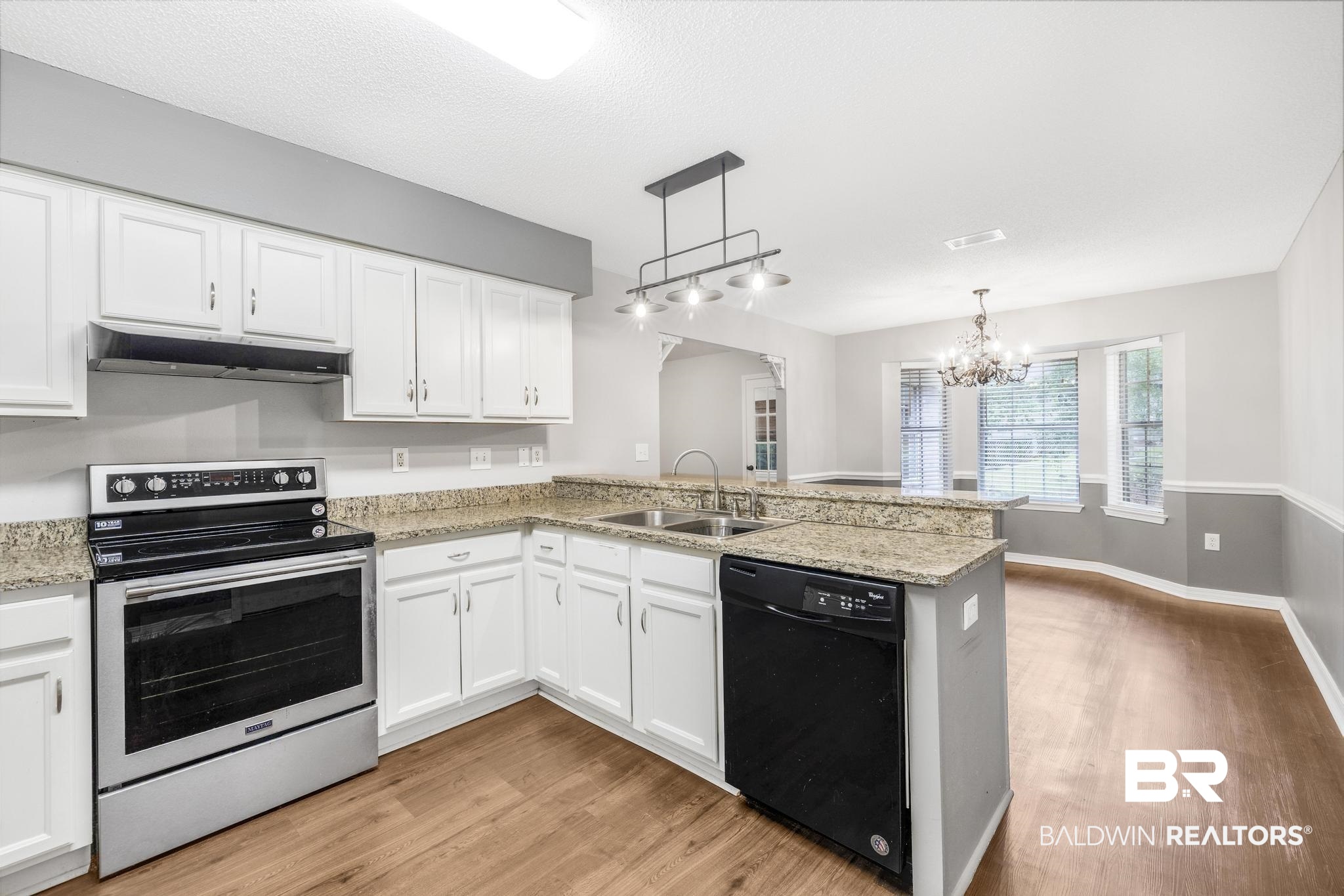 140 Hope Drive Daphne, AL 36526 - Photo 14 of 54 Kitchen featuring electric stove, black dishwasher, a peninsula, white cabinets, and a textured ceiling