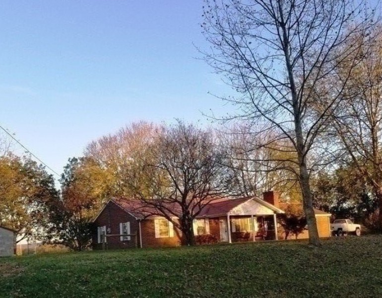 1248 Rutledge Ford Road Decherd, TN 37324 - Photo 1 of 13 a view of a large trees with of a house in the background