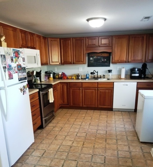 1248 Rutledge Ford Road Decherd, TN 37324 - Photo 4 of 13 a kitchen with stainless steel appliances granite countertop a stove top oven a sink dishwasher and a refrigerator