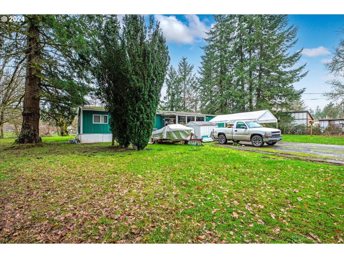 29700 Joe Day Way Grand Ronde, OR 97347 - Photo 4 of 18 a front view of a house with garden