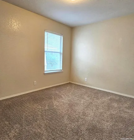 a view of a livingroom with an empty space and a window