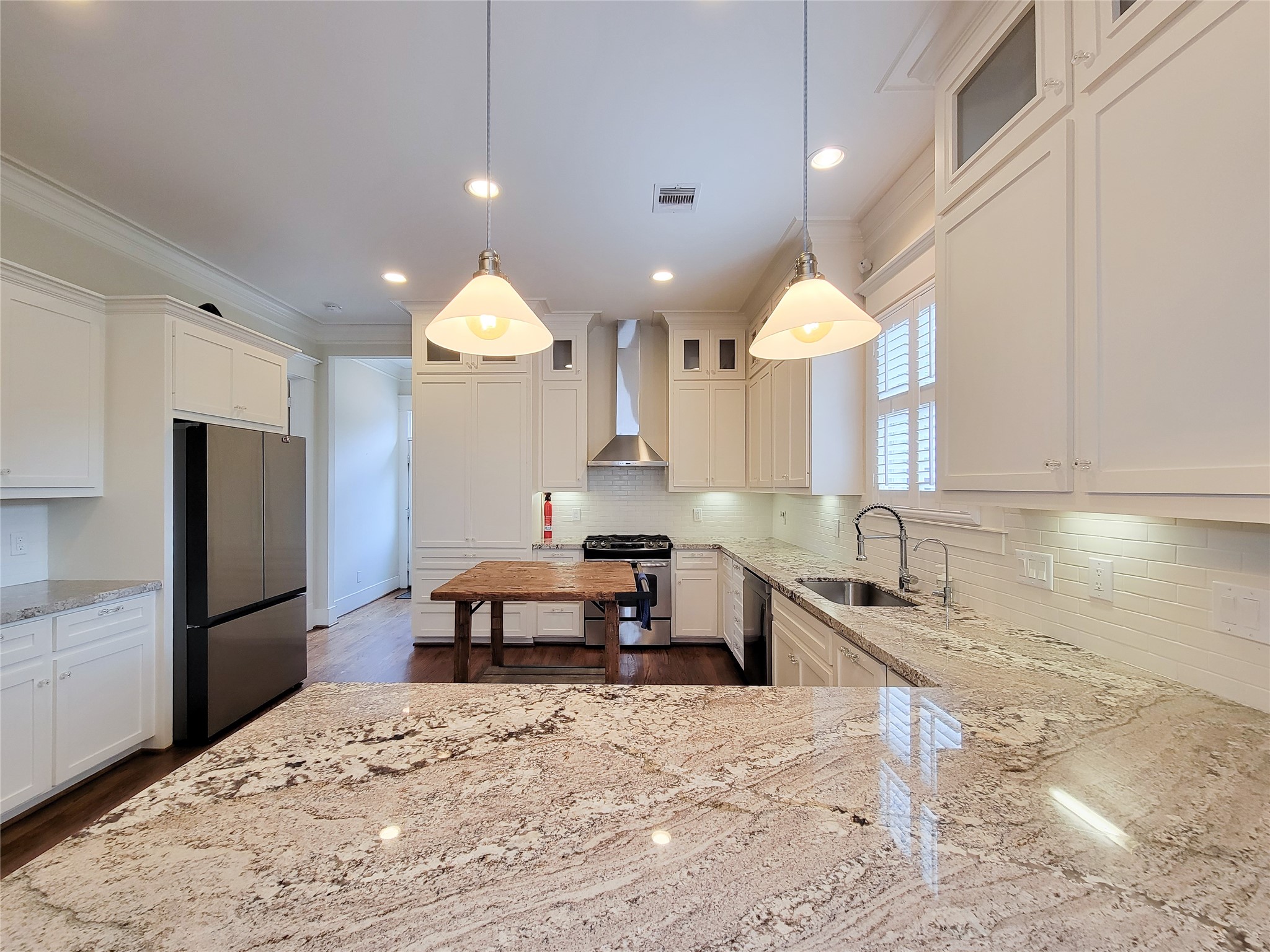 1140 West Cottage Street Houston, TX 77009 - Photo 15 of 37 a kitchen with kitchen island granite countertop a sink a stove and refrigerator