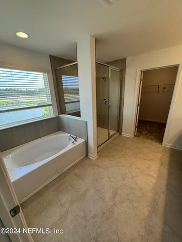 a spacious bathroom with a bathtub and a shower
