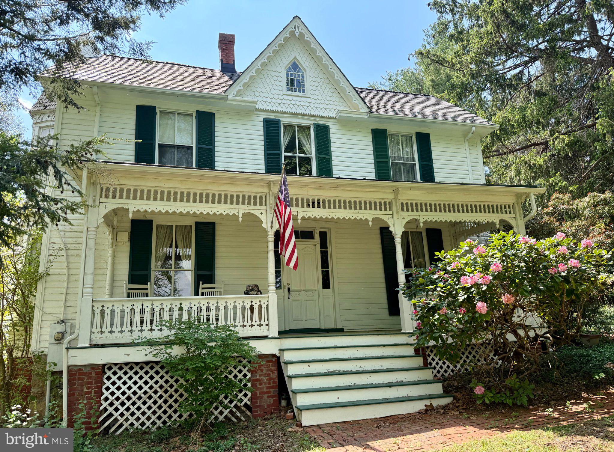 Charming Victorian with lush gardens.
