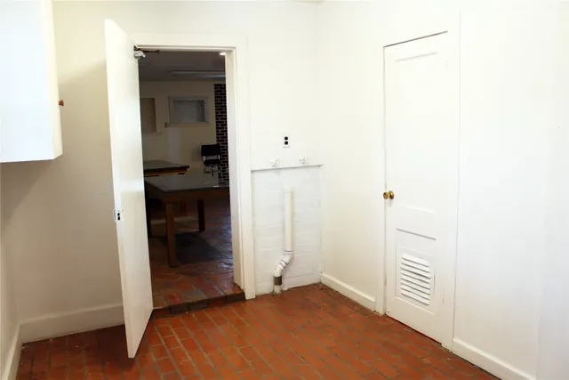 a view of a hallway with closet and wooden floor