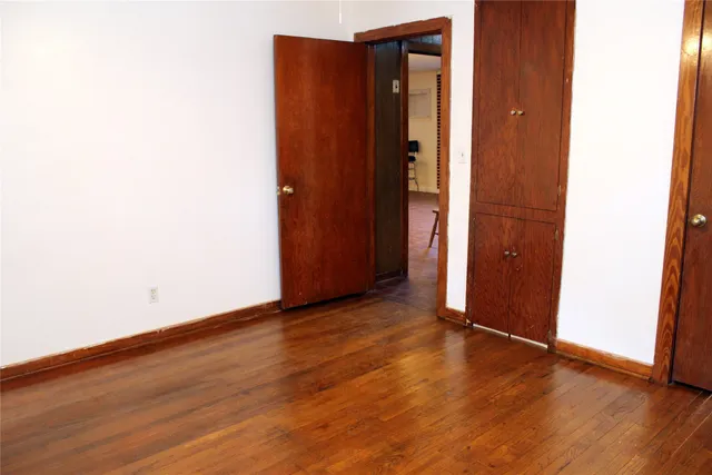 an empty room with wooden floor