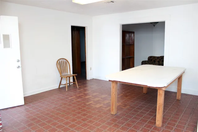 a view of a livingroom with furniture and a window