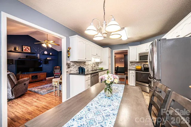 a kitchen with granite countertop stainless steel appliances and wooden cabinets