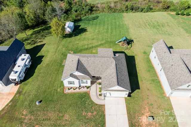 an aerial view of a house with outdoor space and lake view