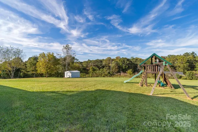 a view of a playground with a house