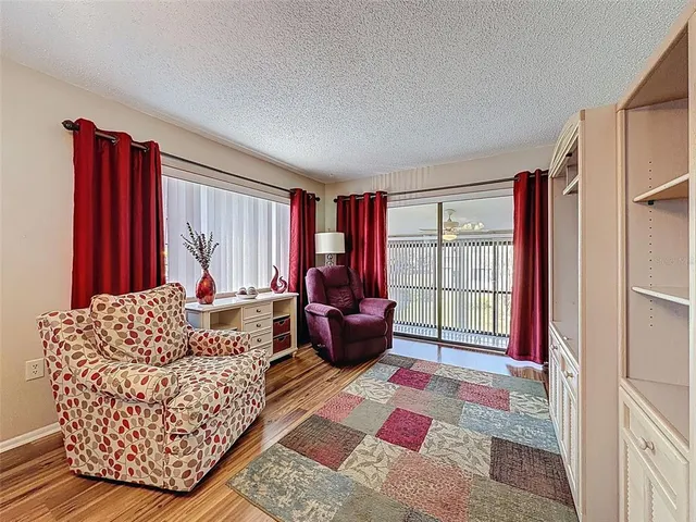 a view of a dining room with furniture wooden floor and chandelier