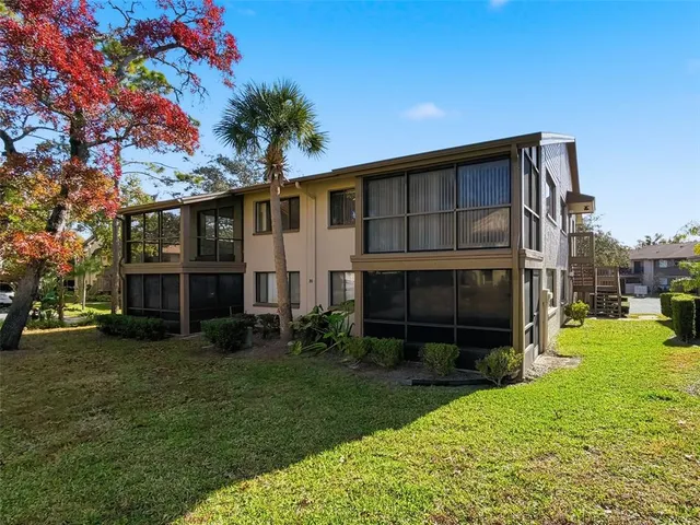 an aerial view of a houses with a yard