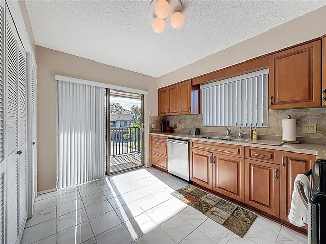 a kitchen with granite countertop a stove cabinets and a refrigerator