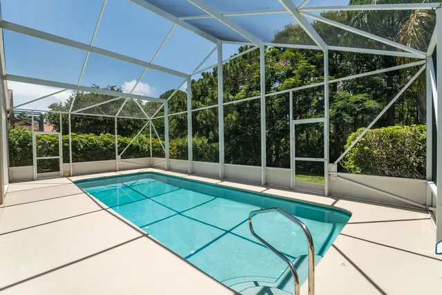a view of a house with a yard and potted plants
