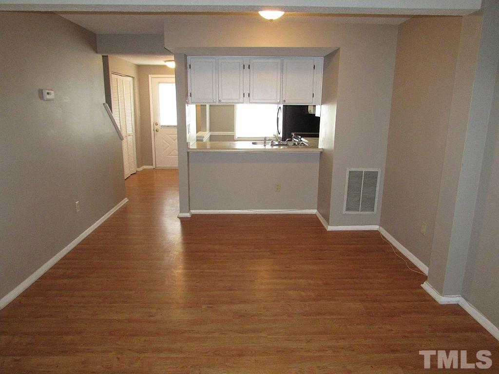 7711 Kelley Court Raleigh, NC 27615 - Photo 4 of 11 a view of a kitchen with a sink stove cabinets and empty room