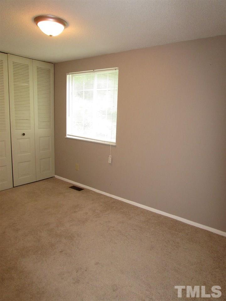 7711 Kelley Court Raleigh, NC 27615 - Photo 7 of 11 an empty room with a window