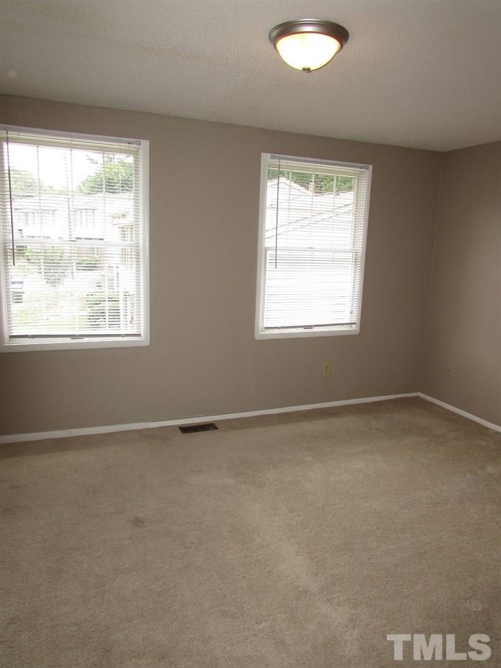 7711 Kelley Court Raleigh, NC 27615 - Photo 9 of 11 an empty room with a window
