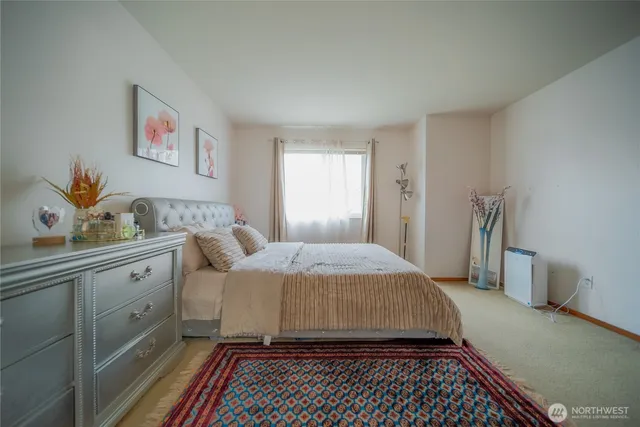 a bedroom with a large bed and a window