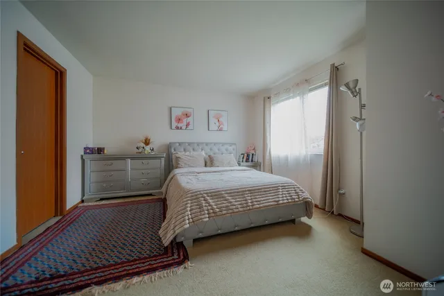 a bedroom with a bed and a window