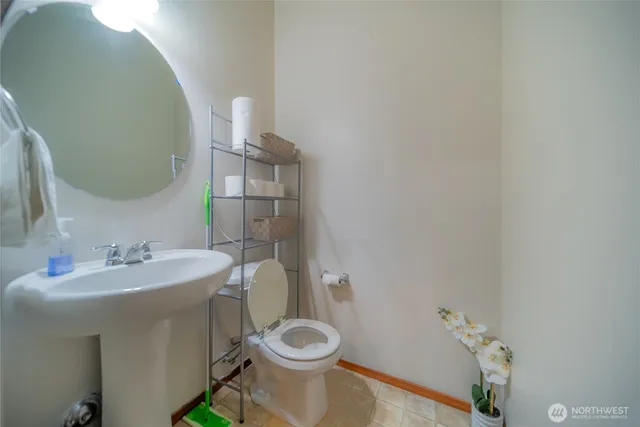 a bathroom with a sink a toilet and a mirror