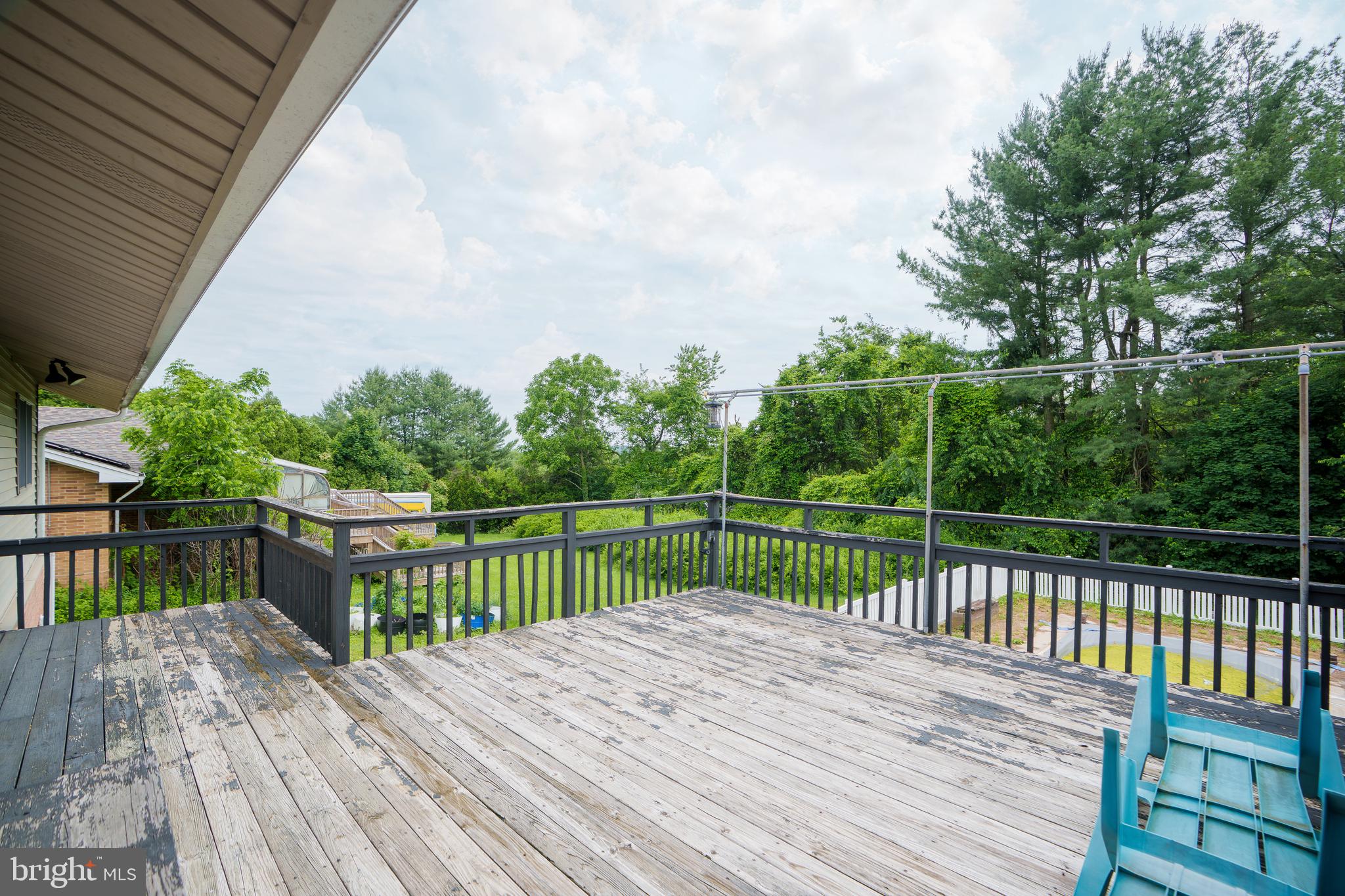 1205 Nottingham Road Newark, DE 19711 - Photo 5 of 47 a view of deck with wooden floor and fence next to a lake