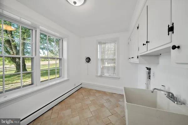 a bathroom with a tub sink and window