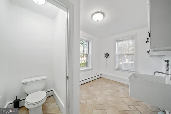 a spacious bathroom with a bathtub sink and toilet