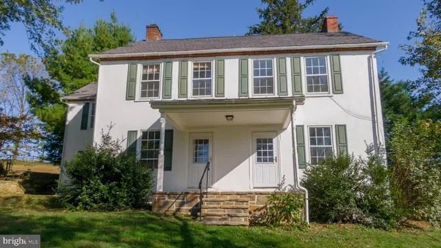 a front view of a house with a yard and porch