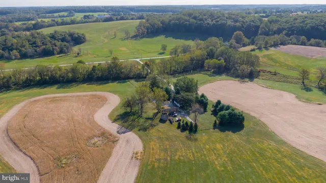 an aerial view of a house with a yard lake and mountain view