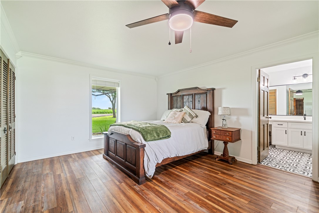 501 South County Road 1140 Riviera, TX 78379 - Photo 18 of 40 Large primary suite with wood-look flooring, neutr