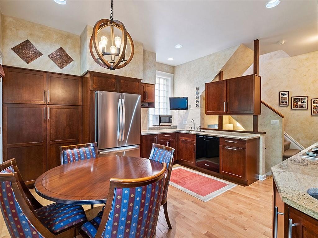 6417 Darlington Road Pittsburgh, PA 15217 - Photo 16 of 40 a dining table with chairs and wooden floor