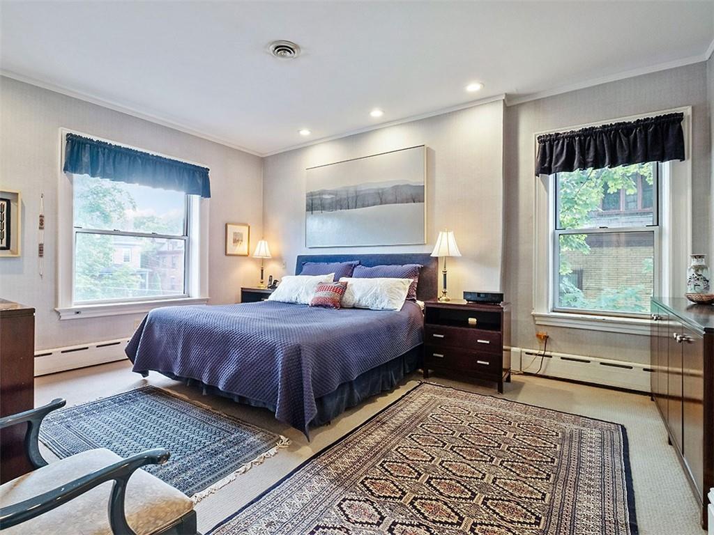 6417 Darlington Road Pittsburgh, PA 15217 - Photo 24 of 40 a bedroom with a bed and wooden floor