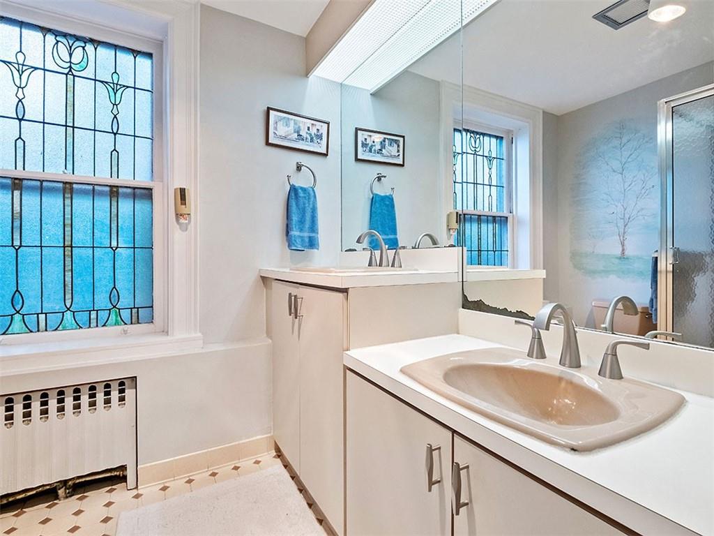 6417 Darlington Road Pittsburgh, PA 15217 - Photo 27 of 40 a bathroom with a sink a mirror and a window