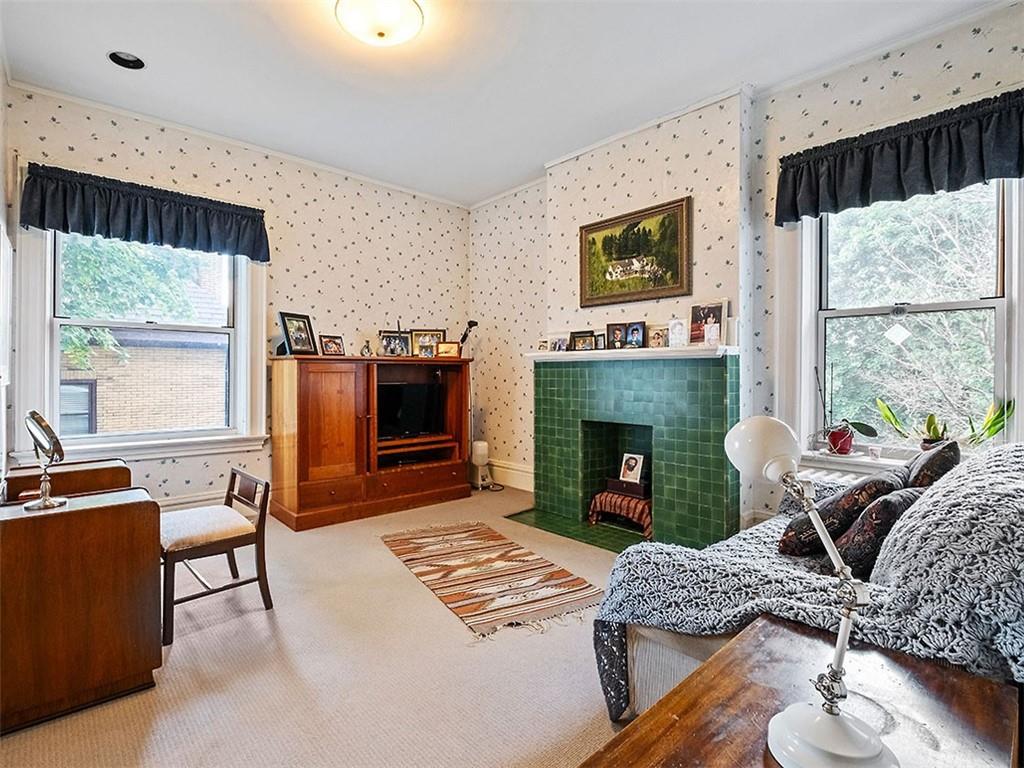 6417 Darlington Road Pittsburgh, PA 15217 - Photo 28 of 40 a living room with furniture a large window and a fireplace