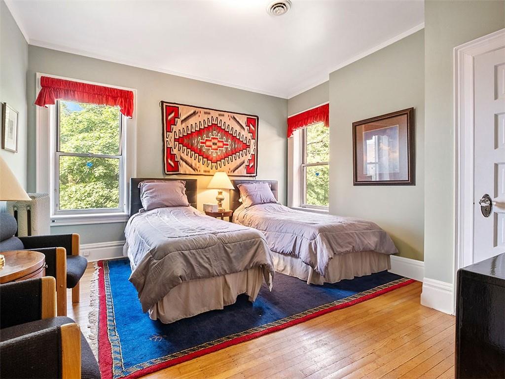 6417 Darlington Road Pittsburgh, PA 15217 - Photo 31 of 40 a bedroom with bed and wooden floor