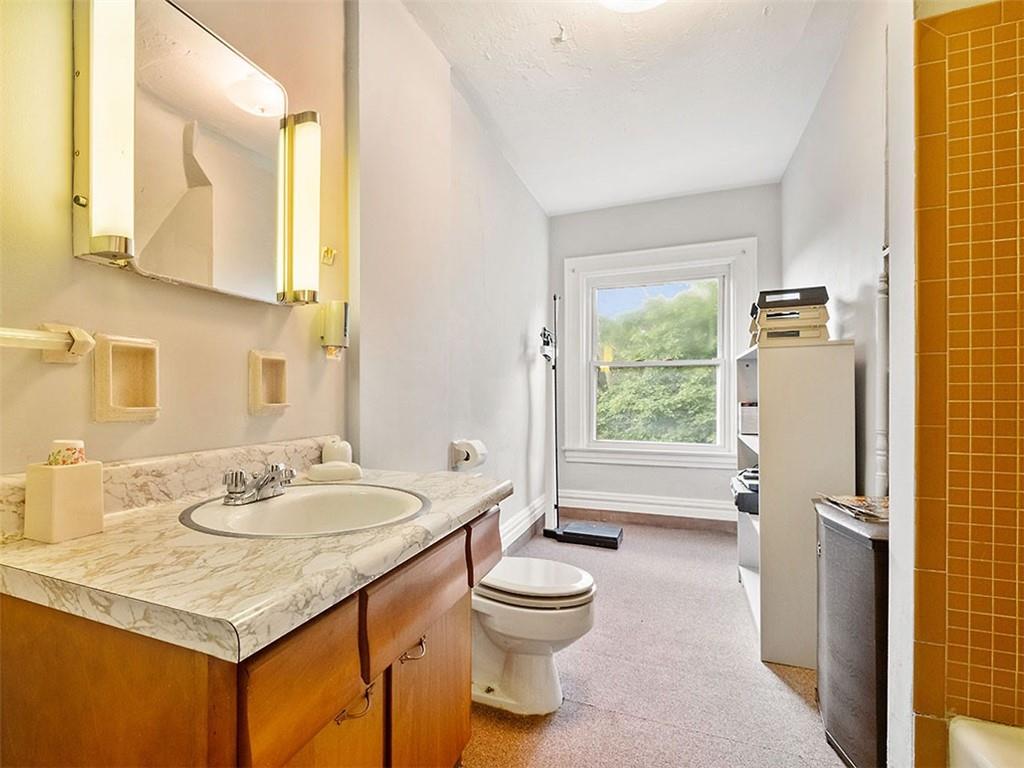 6417 Darlington Road Pittsburgh, PA 15217 - Photo 34 of 40 a bathroom with a granite countertop sink toilet and shower