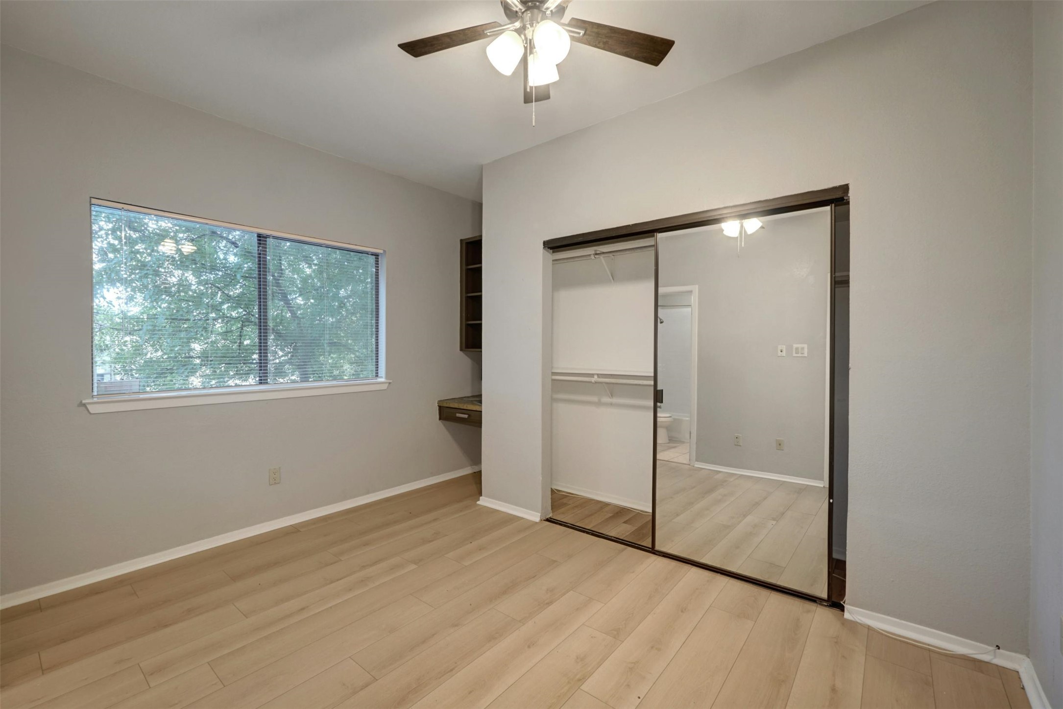 908 Poplar Street, Unit 103 Austin, TX 78705 - Photo 11 of 16 wooden floor in an empty room with a window