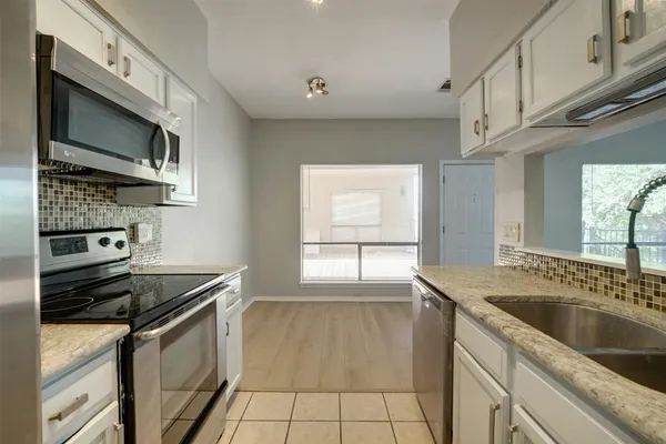 a kitchen that has a sink and a stove