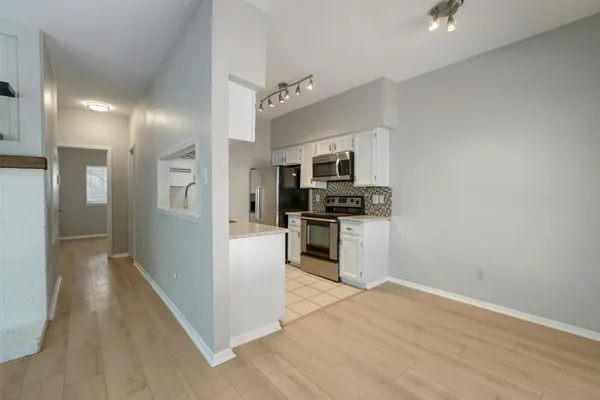 a kitchen with cabinets and stainless steel appliances