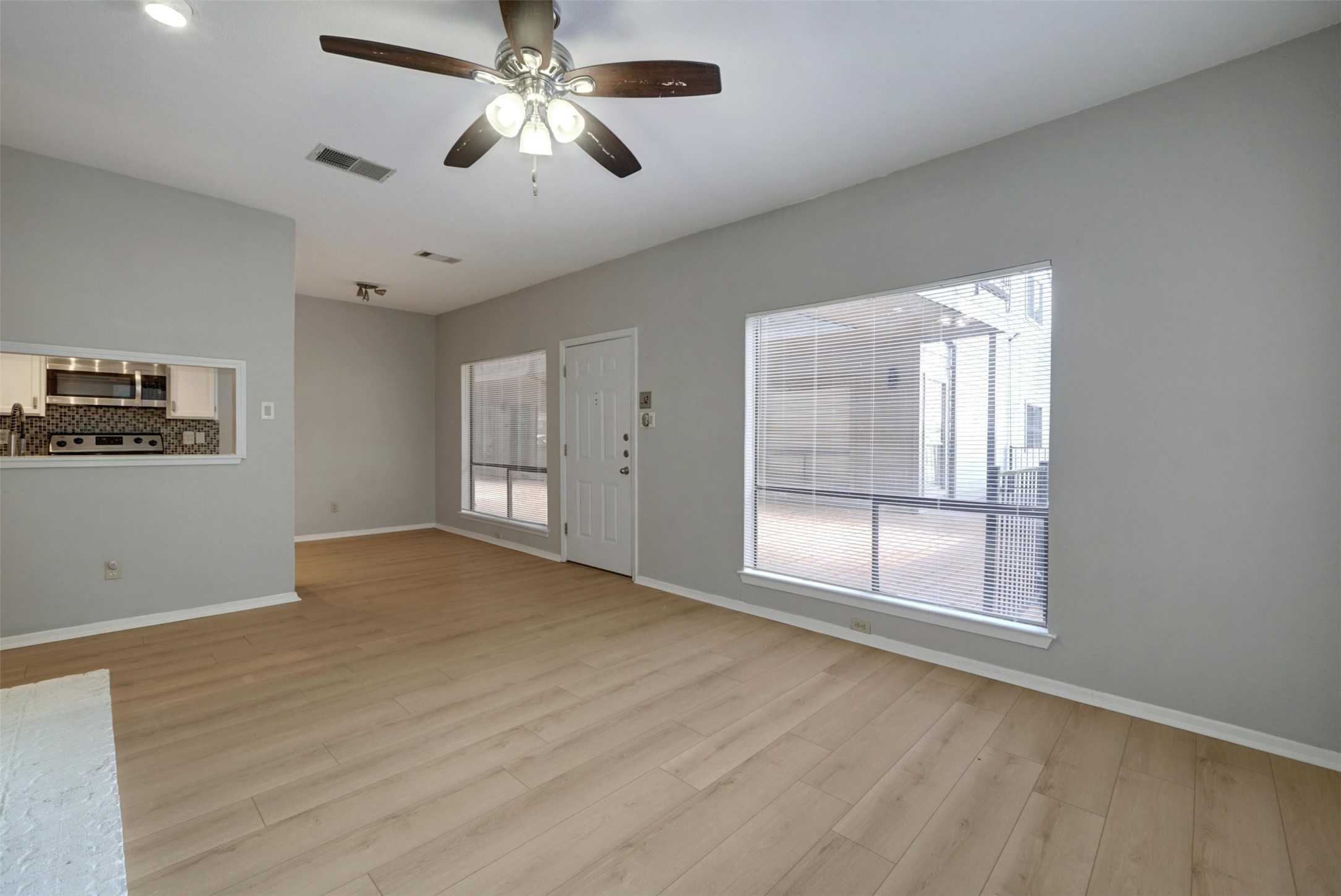 908 Poplar Street, Unit 103 Austin, TX 78705 - Photo 6 of 16 a view of empty room with wooden floor and fan