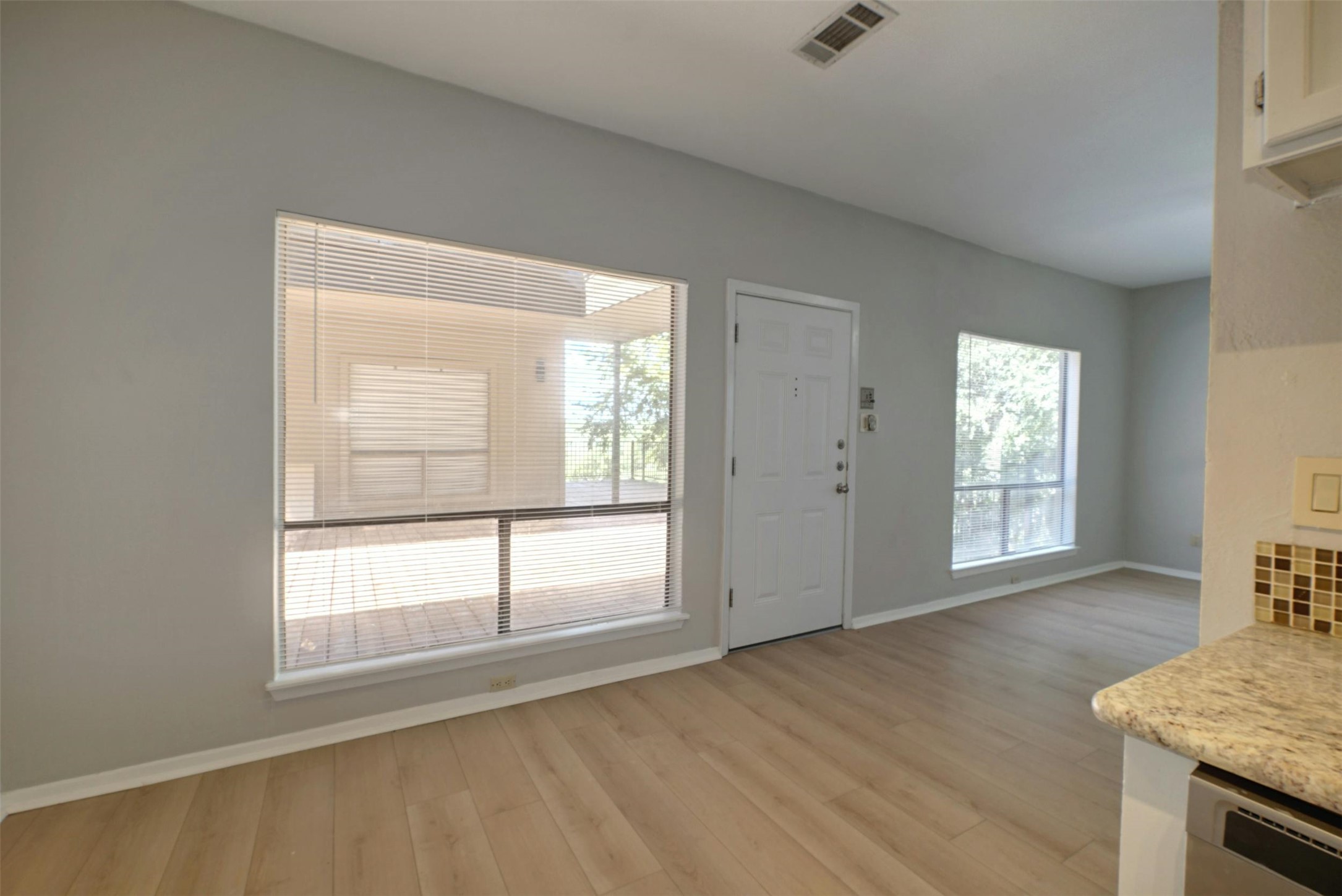 908 Poplar Street, Unit 103 Austin, TX 78705 - Photo 10 of 16 an empty room with wooden floor and windows