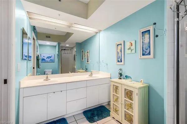 a bathroom with a double vanity sink mirror and