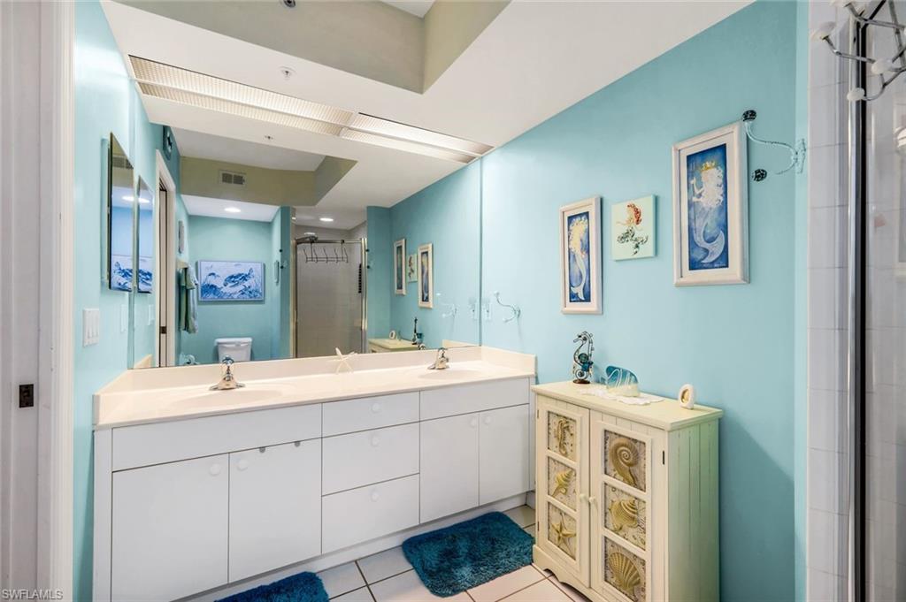 23810 Marbella Bay Road, Unit 103 Estero, FL 34135 - Photo 11 of 32 a bathroom with a double vanity sink mirror and