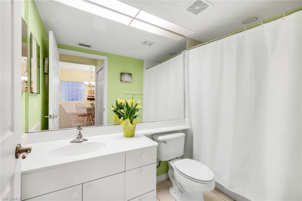 23810 Marbella Bay Road, Unit 103 Estero, FL 34135 - Photo 13 of 32 a bathroom with a sink a toilet and a mirror